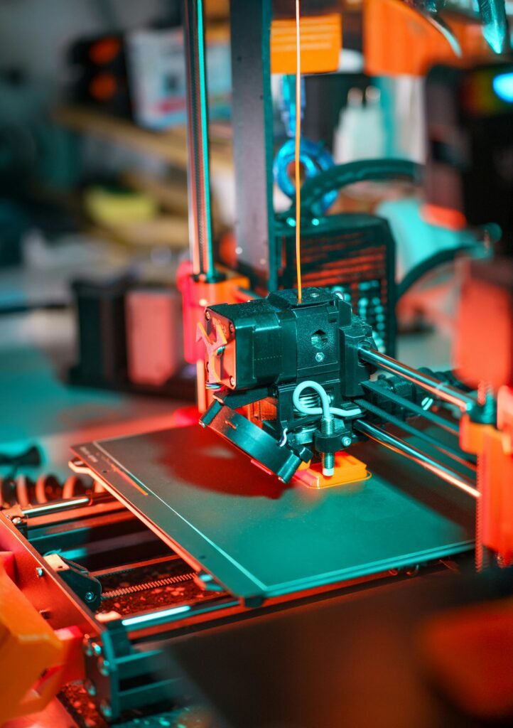 Close-up of a 3D printer crafting a prototype model in a workshop setting.